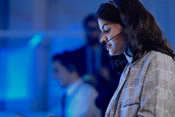 Data analyst deep dive night shift analyzing complex metrics visualizations dashboard screen headset facilitates remote team collaboration insights extraction critical business intelligence achieved.