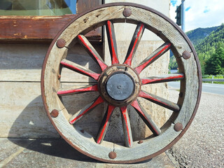 Wooden wheel as decoration for a shop on a city street.