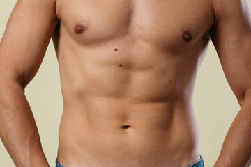 Fototapeta premium A close-up of a slender young man's torso. Male body parts: defined abs and toned chest. Scene: a doctor's appointment in an X-ray room. moles and birthmarks on the body