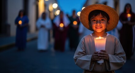Young boy smiling while holding candle during Las Posadas celebration  