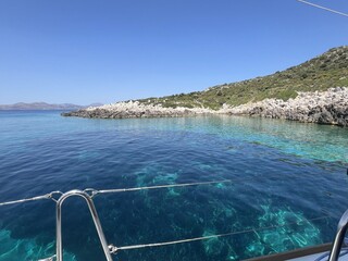 Turquoise coastal waters and rocky shoreline from boat view