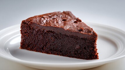 Isolated piece of chocolate fudge dump cake on white ceramic plate, minimal shadow, clean backdrop