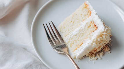 Flat lay of white cake slice with crumbs and fork, minimal setup