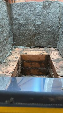 Building a heating stove, The stove core is lined with mineral wool, Close-up, Vertical video