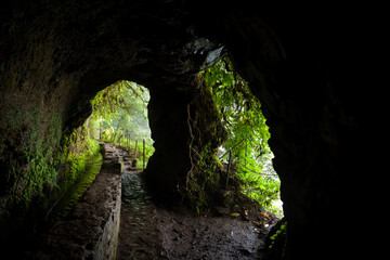 Small tunnel with two openings on Levada do Caldeirao Verde trail in Maderia