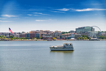 Fototapeta premium National Harbor promenade with ferris wheel and water reflection
