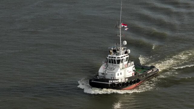 Close-Up Aerial Drone Video of the Tug Boat EN AVANT 9 Sailing in the Harbor or Sea.