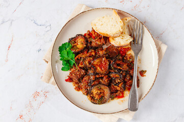 stewed meat with eggplant is a Georgian dish, on a light background,homemade, no people