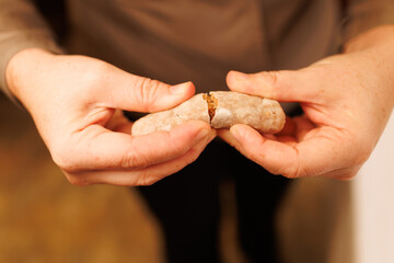 Hands breaking traditional alfajor de medina sidonia pastry
