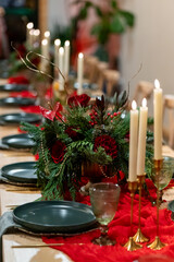 Elegant Christmas Dinner Table Decoration with Candles and Red Accents, pine tree brunches