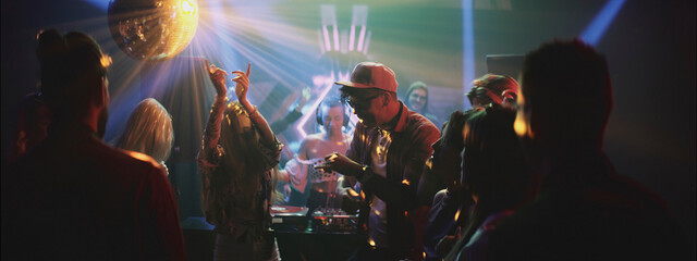 Exciting nightlife scene with people dancing and enjoying music at a vibrant party