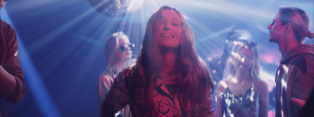 Dance party in a club with vibrant lights and lively people enjoying the night