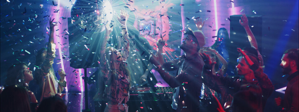 Celebration with vibrant lights and confetti at a lively club event in the night