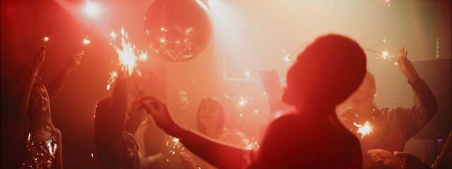Exciting dance party with sparklers and a disco ball in a lively atmosphere