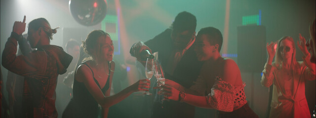 Celebration and joy fill the dance floor during a lively night at the club with friends enjoying drinks and music