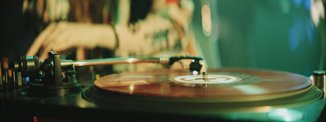 Experience the vibrant atmosphere of a nightclub with a DJ spinning records late at night in the city