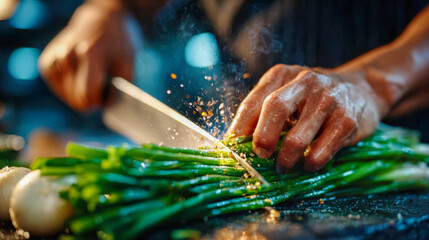 Chef slicing fresh green onions on a wet cutting board, with water droplets flying from the knife