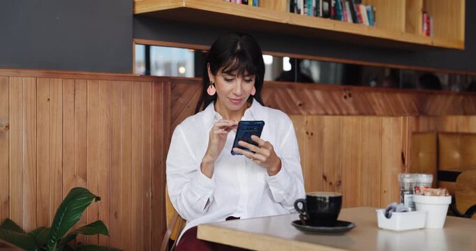 Business woman, phone and scroll in cafe for break, email notification and feedback. Freelance, copywriter and tech with internet for article, proofreading or review in coffee shop for proposal