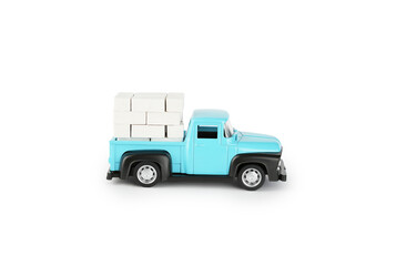 A bright blue toy truck is parked with white boxes stacked neatly in the truck bed. The truck showcases a retro design and stands out against a clean background.