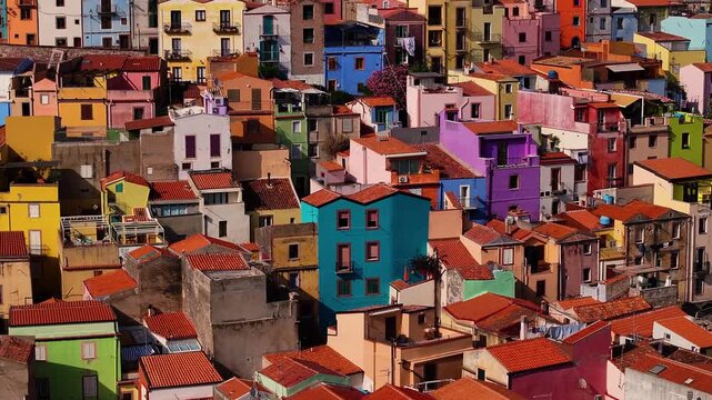 Aerial view of vibrant Bosa, where houses burst with colors, creating a stunning contrast against the terracotta rooftops, Bosa, Sardinia, italy.