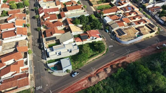 Aerial view shows dense residential neighborhood with red tiled roofs