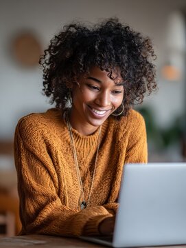 young happy black woman student learning looking at laptop computer watching online webinar having virtual meeting working at home or training seminar class on video call digital conference no logos 