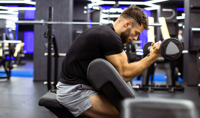 Man performing bicep curls in a modern gym during a fitness session