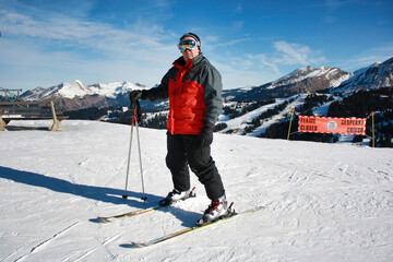 Skier standing on snowy slope in Morzine Avoriaz ski resort, France. Winter sports, mountain...