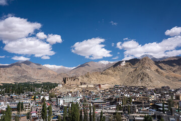 Leh, India - September 12, 2024: View of the city with Leh Palace and with snow capped mountains in the background