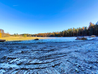 A field covered in snow with trees in the background