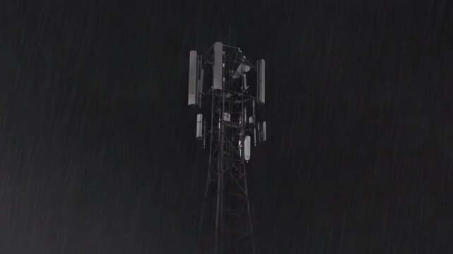 Cellular tower silhouetted against a stormy sky as a bright lightning bolt strikes, disaster concept.