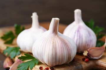 Fresh garlic, peppercorns and parsley on table, closeup