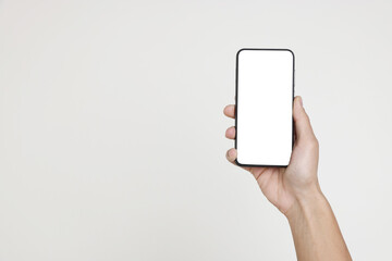 Man holding smartphone with blank screen on white background, closeup. Mockup for design