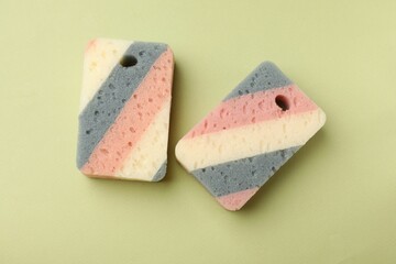 Kitchen sponges on light green background, flat lay
