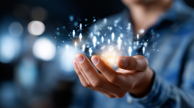 Individual holding illuminated digital representation of person connected to smaller figures faceless man defocused background networking connections symbolism human resources