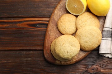 Tasty lemon cookies and fruits on wooden table, flat lay. Space for text