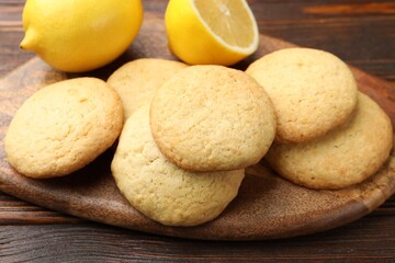 Tasty lemon cookies and fruits on wooden table, closeup