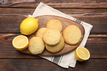 Tasty lemon cookies and fruits on wooden table, flat lay