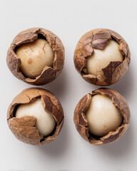 Cracked macadamia nut halves arranged side-by-side