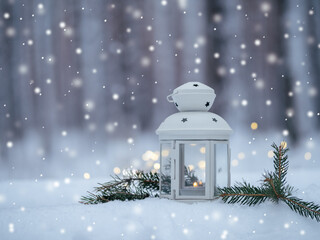 Christmas lantern with candle on snow in winter forest copy space