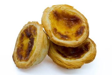  Three Delightful golden Portuguese egg tarts showcasing a flaky crust and rich caramelized custard.