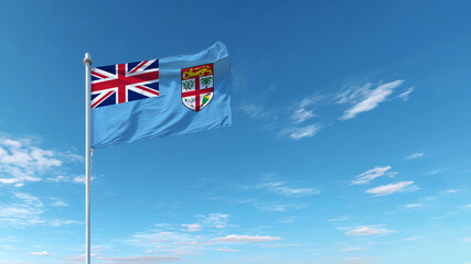 Fiji flag waving against a clear blue sky, symbolizing national pride and sovereignty