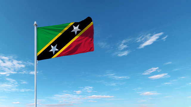 Flag of Saint Kitts and Nevis waving proudly against a clear blue sky