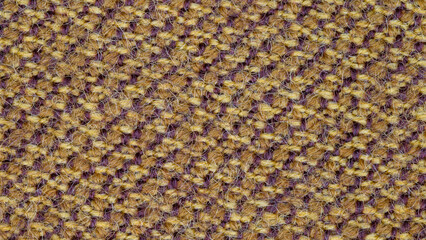 Macro photo of fabric texture for use as background. The fabric is made from a mixture of orange and purple threads. A mixture of synthetics and wool. Abstract pattern.