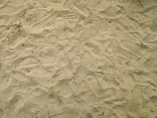 Overhead view of playground sand surface with shoe prints and footprints. Trace, track, swing park floor texture, activity and recreational area, leisure, play, outdoor, textured natural background.