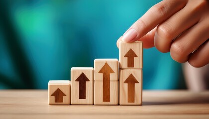 hand stacking wooden blocks with upward arrow symbols