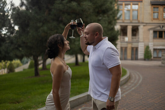 A beautiful couple celebrates their anniversary with wine