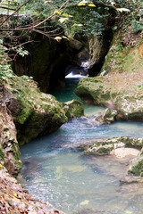 A breathtaking canyon filled with crystal-clear water that perfectly mirrors the towering rock walls rising from its surface.