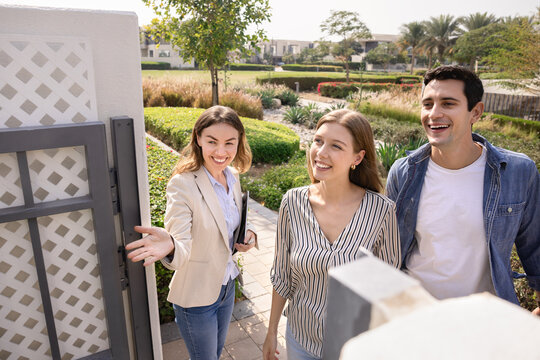 Couple visiting garden area with real estate agent