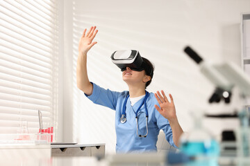 Modern technology. Doctor with headset using virtual screen in office